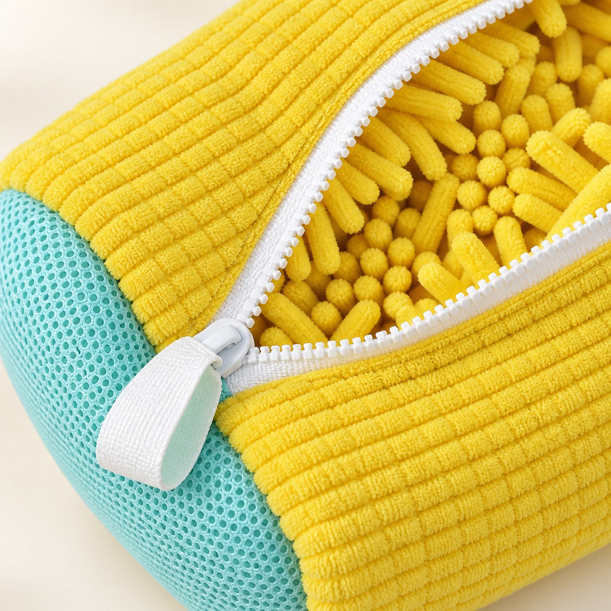 Close-up of the ScrubKix zipper, aqua mesh end panel, and yellow chenille interior